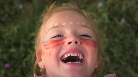 Portrait of a happy hippie child with patterns on his face. Stock Footage 146873019