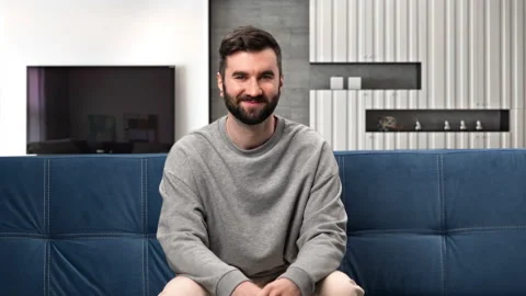 Portrait happy Hispanic man posing on couch at modern living room relaxing Stock-Footage 229714794