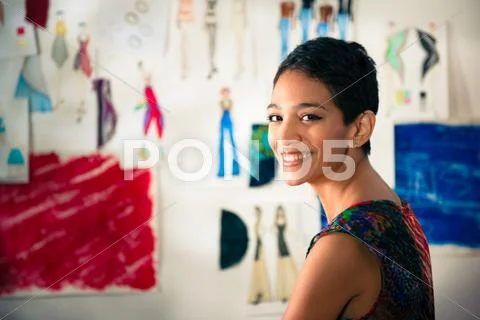 Portrait of happy hispanic young woman working as fashion designer Stock-Fotos