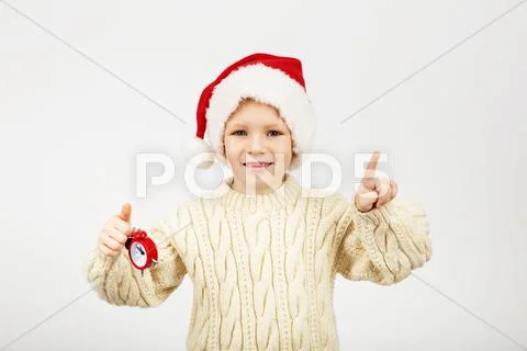 Portrait of happy joyful beautiful little boy wearing Santa hat against white Stock Photos