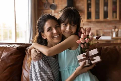 Portrait of happy Latino mom and daughter hugging Stock Photos