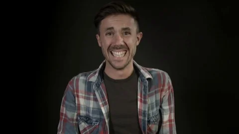 Portrait of a happy laughing man, close-up. Happy man on black background Video stock 80303592