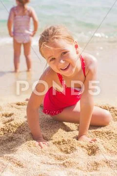 Portrait of Happy Little Girl on the sandy beach. Summer vacation. Stock Photos