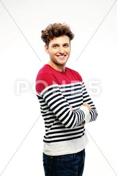 Portrait of a happy man with arms folded over white background Stock Photos