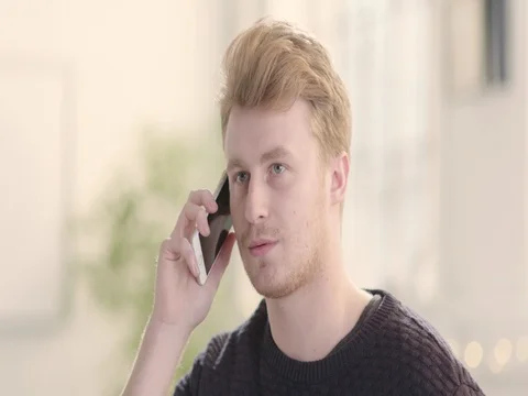 Portrait of happy man in bright startup office using mobile phone track right Stock Footage 72888089