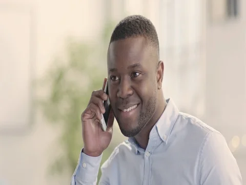 Portrait of happy man in bright startup office using mobile cell phone - static Stock Footage 72889580