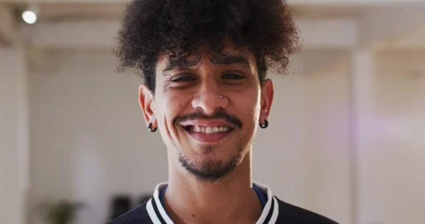 Portrait of happy man looking at camera in dance studio, slow motion Stock Footage 344332945
