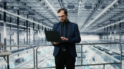 Portrait of happy man reviewing microchips plant analytics using laptop Stock Footage 333379455