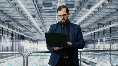 Portrait of happy man reviewing microchips plant analytics using laptop Stock Footage 333383868