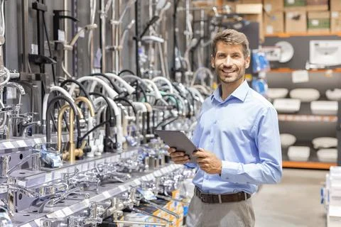 Portrait of happy man using digital tablet in hardware store Stock Photos