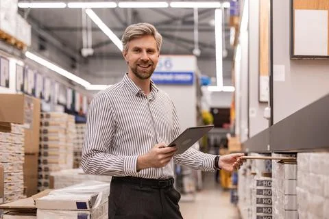 Portrait of happy man using digital tablet in hardware store Stock Photos