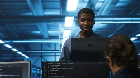 Portrait of happy manager supervising server rows in data center 库存照片