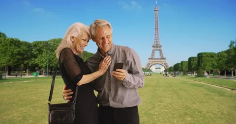 Portrait of happy mature couple using smartphone in Paris Stock Footage 85603633