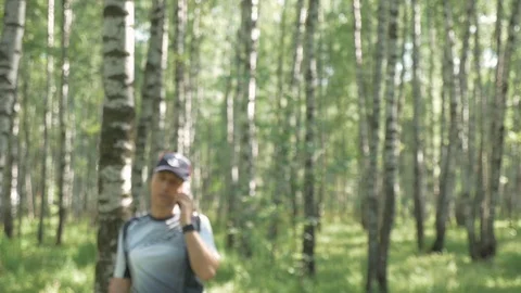 Portrait of a happy middle-aged man. He goes in for sports in the park and talks 스톡 동영상 92201564