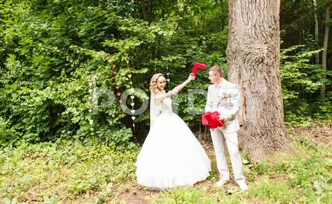 Portrait Of Happy Newlywed Couple Fighting With Decorative Letters