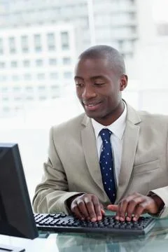 Portrait of a happy office worker using a computer Stock Photos