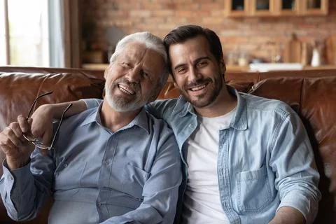Portrait of happy old father and adult son rest together Stock Photos