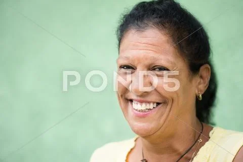 Portrait of happy old hispanic woman smiling at camera Stock Photos