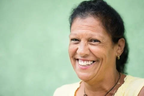 Portrait of happy old hispanic woman smiling at camera Stock Photos