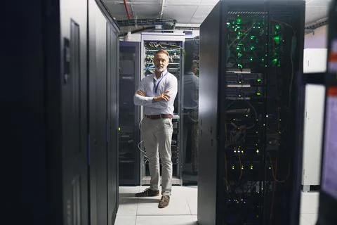 Portrait, happy or technician in server room with arms crossed, pride or Stock Photos