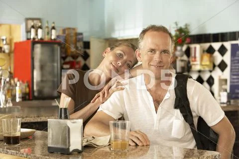 Portrait Of Happy Relaxed Couple In Bar Stock Photos