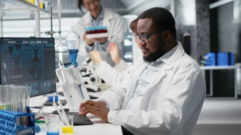 Portrait of happy scientist using computer program for DNA data analysis Stock Footage 320722198