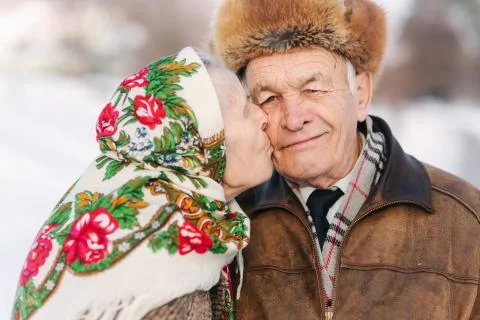 Portrait of happy senior couple. Elderly woman kiss her husband in weighty. old Stock Photos