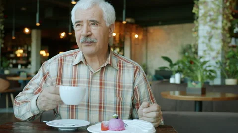 Portrait of happy senior man drinking tea enjoying leisure time in restaurant Stock Footage 143900514