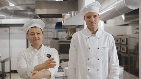 Portrait of happy smiling chefs in industrial kitchen Stock Footage