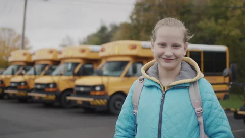 Portrait of a happy student against the background of a typical yellow school Stock Footage 250644580