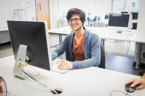 Portrait of happy student using computer 写真素材