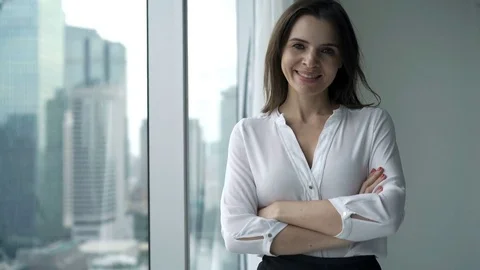 Portrait of happy, successful businesswoman standing by window at home Stock Footage