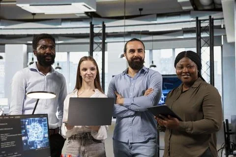 Portrait of happy teamworking programmers utilizing AI to optimize performance Stock Photos
