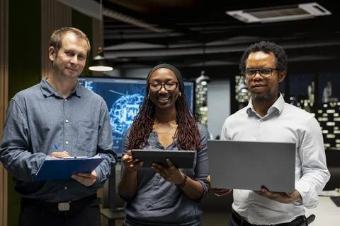 Portrait of happy teamworking programmers utilizing AI to optimize performance 스톡 사진