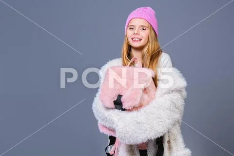 A portrait of a happy trendy schoolgirl with a backpack. Fashion, beauty. Tee Stock Photos