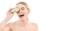 The portrait of the happy woman with an avocado on the white background Photo