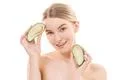 The portrait of the happy woman with an avocado on the white background Photo