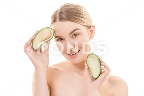 The portrait of the happy woman with an avocado on the white background Stock Photos