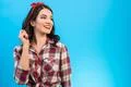 The portrait of the happy woman on the blue background Photo