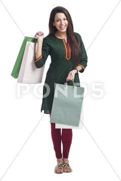 Portrait of a happy woman carrying shopping bags Stock Photos