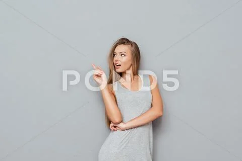 Portrait of a happy woman pointing finger away Stock Photos