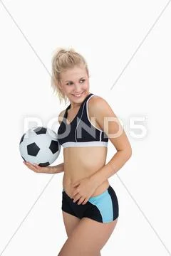Portrait of happy woman in sportswear with football Stock Photos