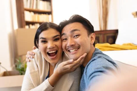 Portrait of happy young asian couple enjoying liesure time at home Stock Photos
