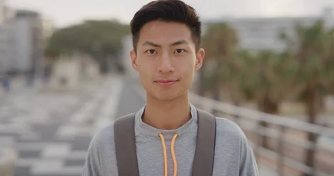 Portrait happy young asian man tourist smiling enjoying summer vacation Stock Footage