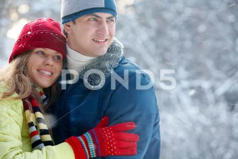 Portrait of happy young family spending time outdoors in winter Stock Photos