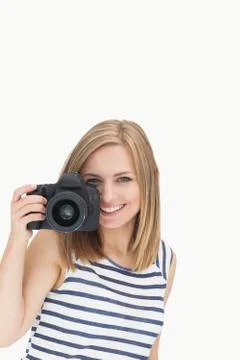 Portrait of happy young female with photographic camera Stock Photos