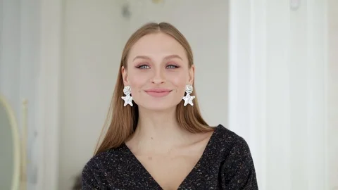 Portrait of a happy young lady looking at the camera and smiling and then Видео 127043597