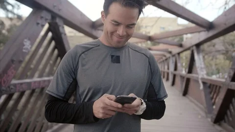 Portrait of happy young man communicating on smartphone smiling, confident Stock Footage 104490355