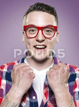 Portrait of happy young man with red glasses, studio shot Stock Photos