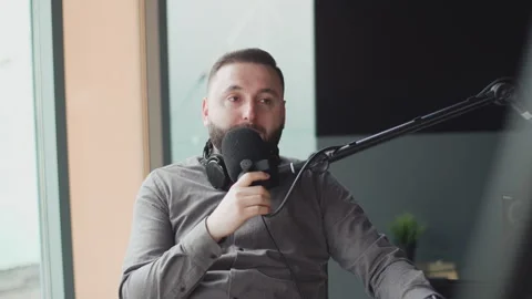 Portrait of happy young man working as radio host at radio station. Vidéo 240705604